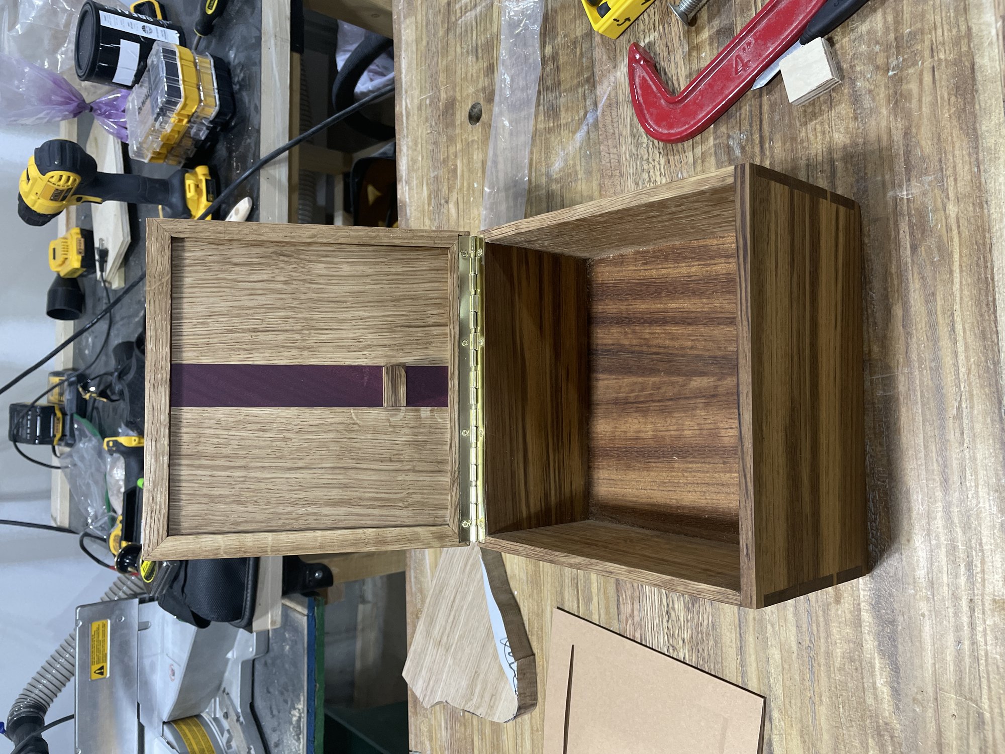 Open from above: oak lid with purpleheart stripe on a brass hinge, empty teak and oak box.