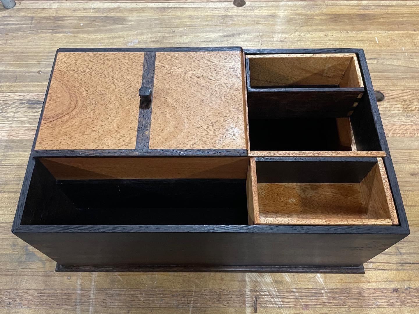 Overhead view of the assembled box: sliding mahogany lid on the left, open wenge and mahogany pockets on the right.